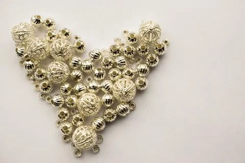 Selection of different silver beads shaped into a heart Stock Photos