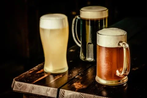 Selection of different types of beer in glasses in pub background Stock Photos