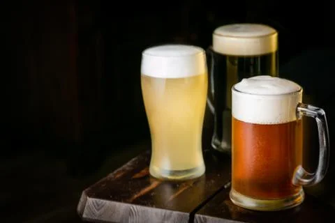 Selection of different types of beer in glasses in pub background Stock Photos