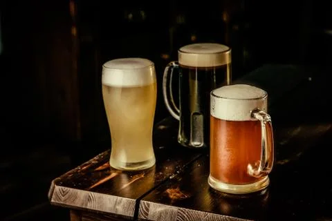 Selection of different types of beer in glasses in pub background Stock Photos