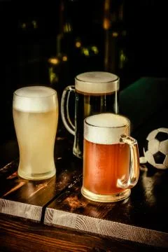 Selection of different types of beer in glasses in pub background Stock Photos