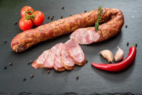 Selection of different types of salami. Organic products on a wooden table Stock Photos