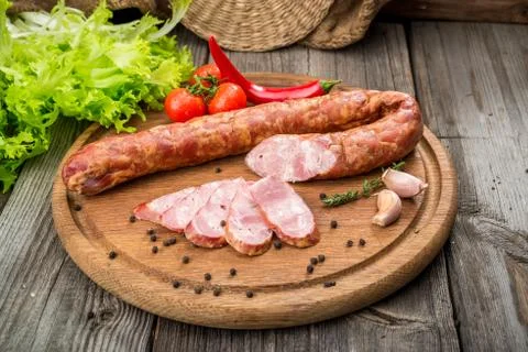 Selection of different types of salami. Organic products on a wooden table Stock Photos