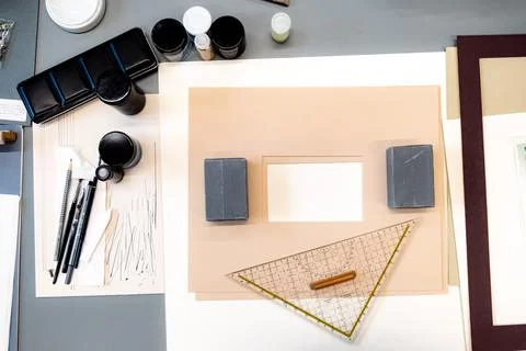 Selection of drawing materials including triangle ruler, shower pen, frames Stock Photos