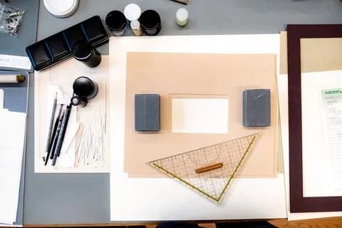 Selection of drawing materials including triangle ruler, shower pen, frames Stock Photos