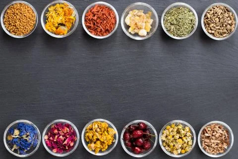 Selection of dried herbs on a dark background with copy space, top view Stock Photos