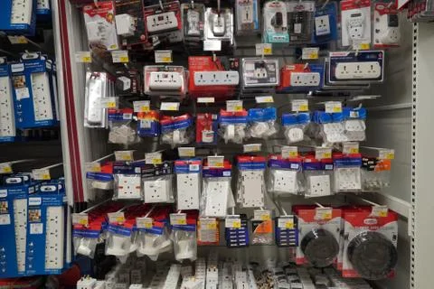 Selection of extension 3 pin plug socket wire on supermarket. Many adapter po Stockfoto's