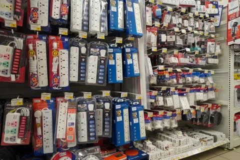 Selection of extension 3 pin plug socket wire on supermarket. Many adapter po Stockfoto's