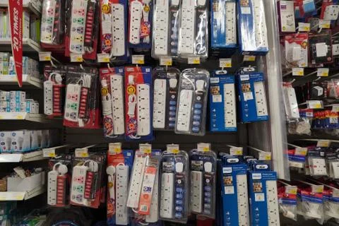 Selection of extension 3 pin plug socket wire on supermarket. Many adapter po Stock Photos