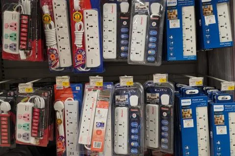 Selection of extension 3 pin plug socket wire on supermarket. Many adapter po Stockfoto's