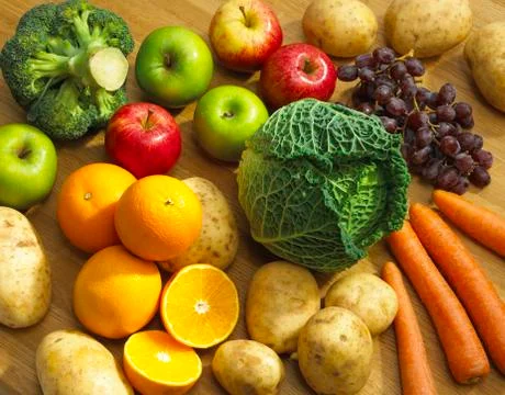 SELECTION OF FRESH FRUIT AND VEGETABLES ON KITCHEN TABLE Stock Photos
