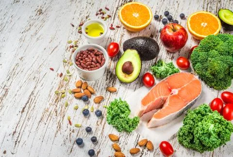 Selection of fresh fruit and vegetables, salmon, beans, and nuts. Stock Photos