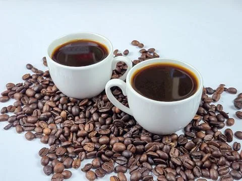 A Selection of Freshly Brewed Coffee Cups Tastefully Surrounded by Fresh Co.. Stock Photos