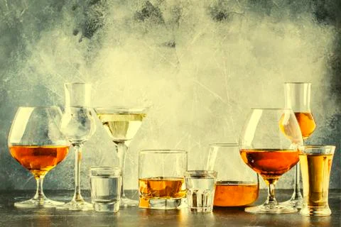 Selection of hard strong alcoholic drinks in big glasses and small shot glass Stock Photos