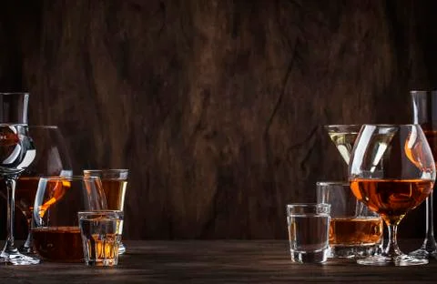 Selection of hard strong alcoholic drinks in big glasses and small shot glass Stock Photos