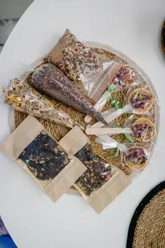A selection of loose leaf tea and dried citrus fruits in individual packaging Stock Photos