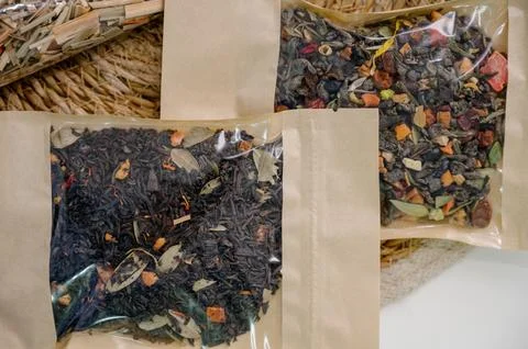 A selection of loose leaf tea and dried citrus fruits in individual packaging Stock Photos