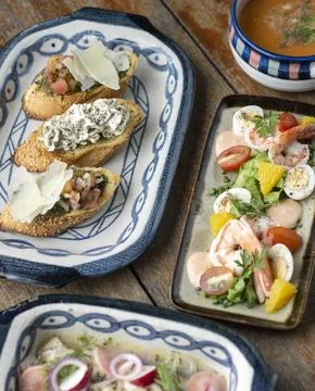 Selection of many different tapas on rustic wood table Stock Photos