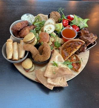 A selection of many different tapas  on a wooden plate Stock Photos