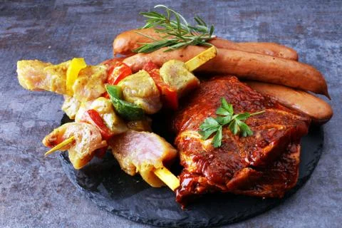 Selection of marinaded meat for bbq grilling with herbs on table Stock Photos