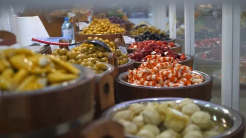 Selection of middle eastern pickled food displayed in bins on a fresh food Stock Footage 157411915