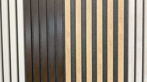 A selection of multi colored wood slats on dark acoustic felt panels showin.. Stock Photos