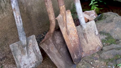 A selection of old, well used rusty tools - spades and shovels - outside Video stock 157149554