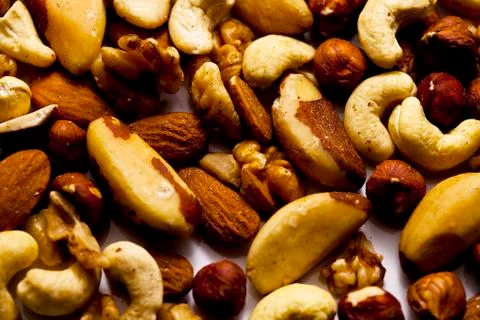 A Selection of Organic Nuts on White Surface Stock Photos