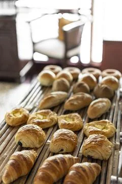 Selection of pastries and bread on display in french cafe buffet Stock Photos