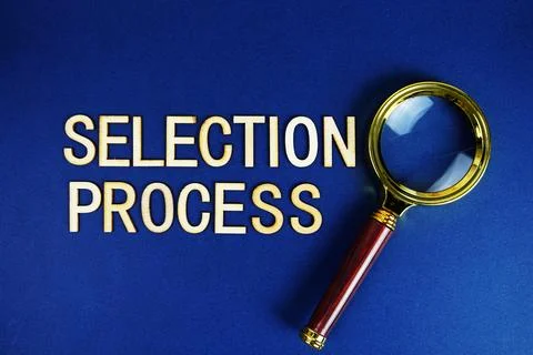 Selection  Process alphabet letters with magnifying glass on navy blue back.. Stock Photos