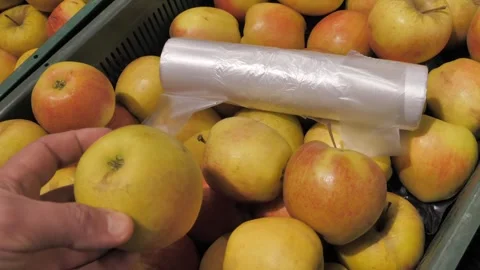 Selection of ripe yellow apples, plastic container, roll bags Stock Footage 306178980
