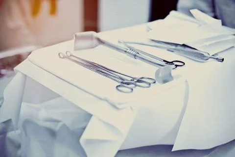 Selection of sharp medical tools on a colored fabric background Stock Photos