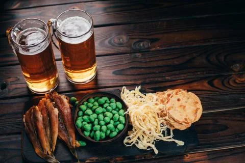 Selection of snacks and seafood two mugs of beer Stock Photos