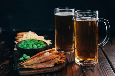 Selection of snacks and seafood two mugs of beer Stock Photos