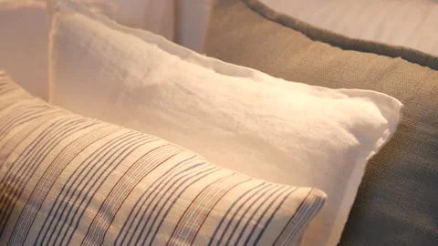 Selection of soft decorative linen pillows on cozy bed in modern bright bed.. Stock-Footage 332891615