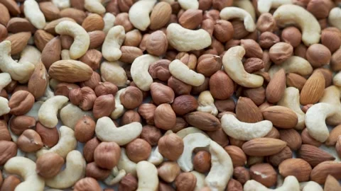 Selection of Useful Shelled Nuts Hazelnut Cashew Almond is Spinning on the Platt Video stock 141666881