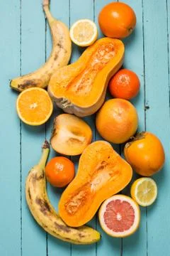 A selection of various fresh yellow raw organic produce fruits and vegetables Stock Photos
