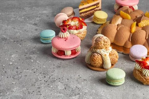 Selection of various pieces of cake - Choux pastries, macarons, chocolate vel Stock Photos