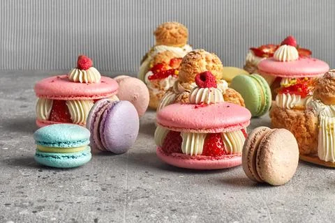 Selection of various pieces of cake - Choux pastries, macarons, chocolate vel Stock Photos