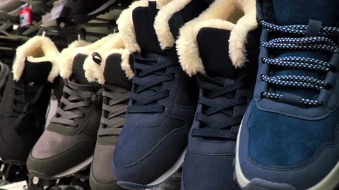 A selection of warm athletic shoes on display in the store. Stock Footage 221852465