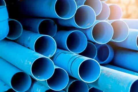 Selective to blue plastic pipe background. PVC pipes stacked in warehouse of  Stockfoto's