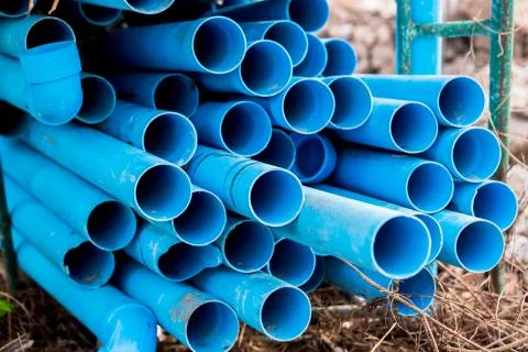 Selective to blue plastic pipe background. PVC pipes stacked in warehouse of  Stock Photos