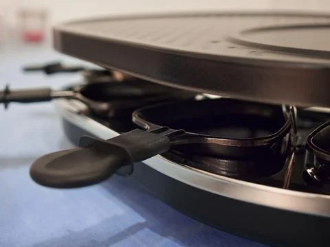 Selective closeup  of a raclette grill on a table Foto stock