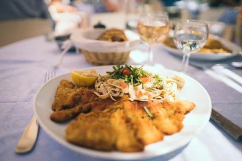 A selective closeup shot of chicken fried steak and pasta in a white ceramic  Stock Photos