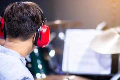 Selective to ear muffs over head of musicians drummer to play drum set in mus Stock Photos