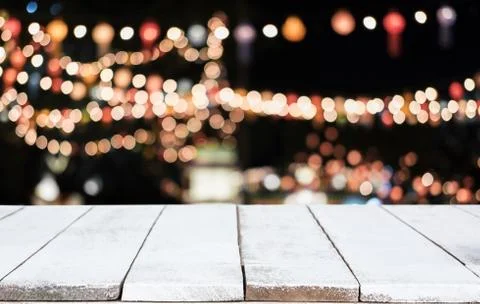Selective Empty wooden table in front of abstract blurred festive light backg Stock Photos