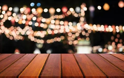 Selective Empty wooden table in front of abstract blurred festive light backg Stock Photos