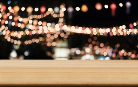 Selective Empty wooden table in front of abstract blurred festive light backg Stock Photos