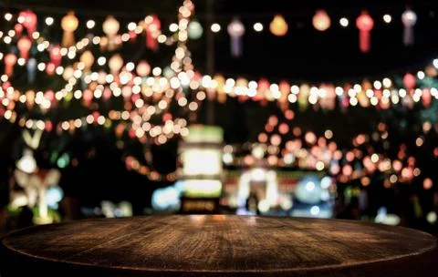 Selective Empty wooden table in front of abstract blurred festive light backg Stock Photos