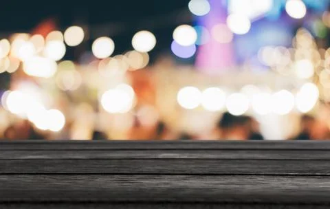 Selective Empty wooden table in front of abstract blurred festive light backg Stock Photos
